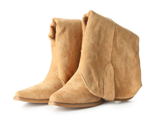 A pair of women's tan suede cowgirl boots, featuring subtle embroidery on the boot shafts, sitting on a white background.